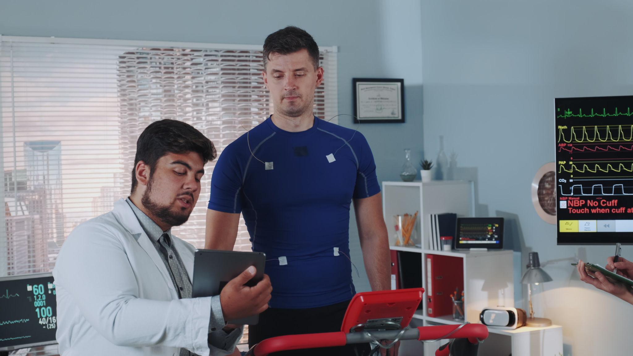 Doctor discussing cardiovascular health risks and medical test results with a strength athlete